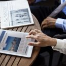 business-man-reading-newspaper-business-woman-reading-news-with-her-digital-device-scaled.jpg