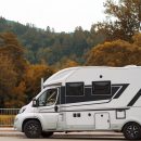 motorhome-parked-outdoors-forest-setting-scaled.jpg